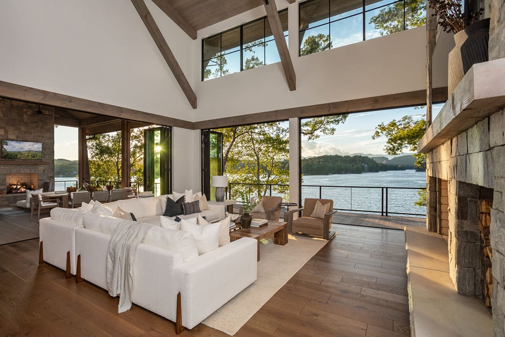 Living room with stone fireplace, view of lake keowee