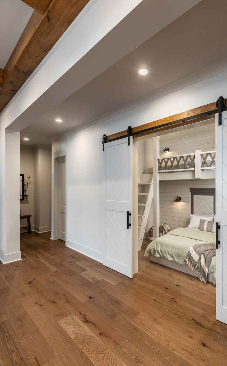 Bunkbeds in bedroom with sliding barn doors