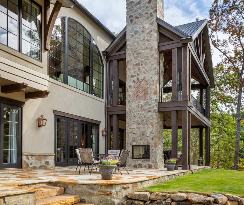 Rear of the home showing stonework and 2-story porch with timbers