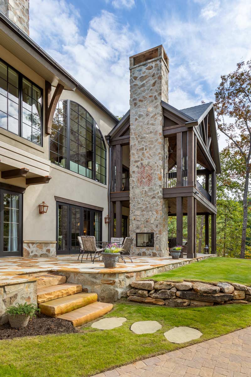 Rear of the home showing stonework and 2-story porch with timbers