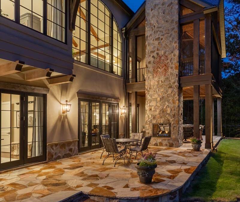 The rear of the home seen at night with stonework