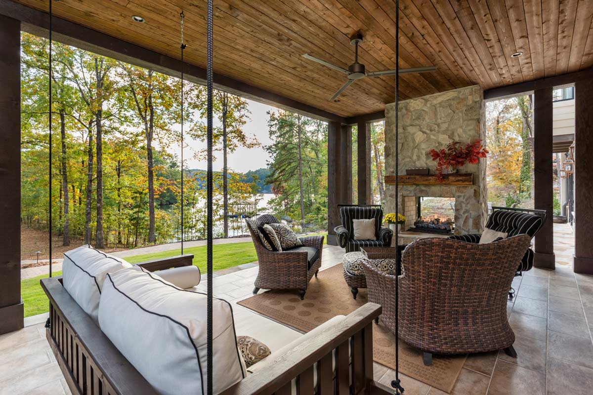 first-floor outdoor living space with fire place and lake views