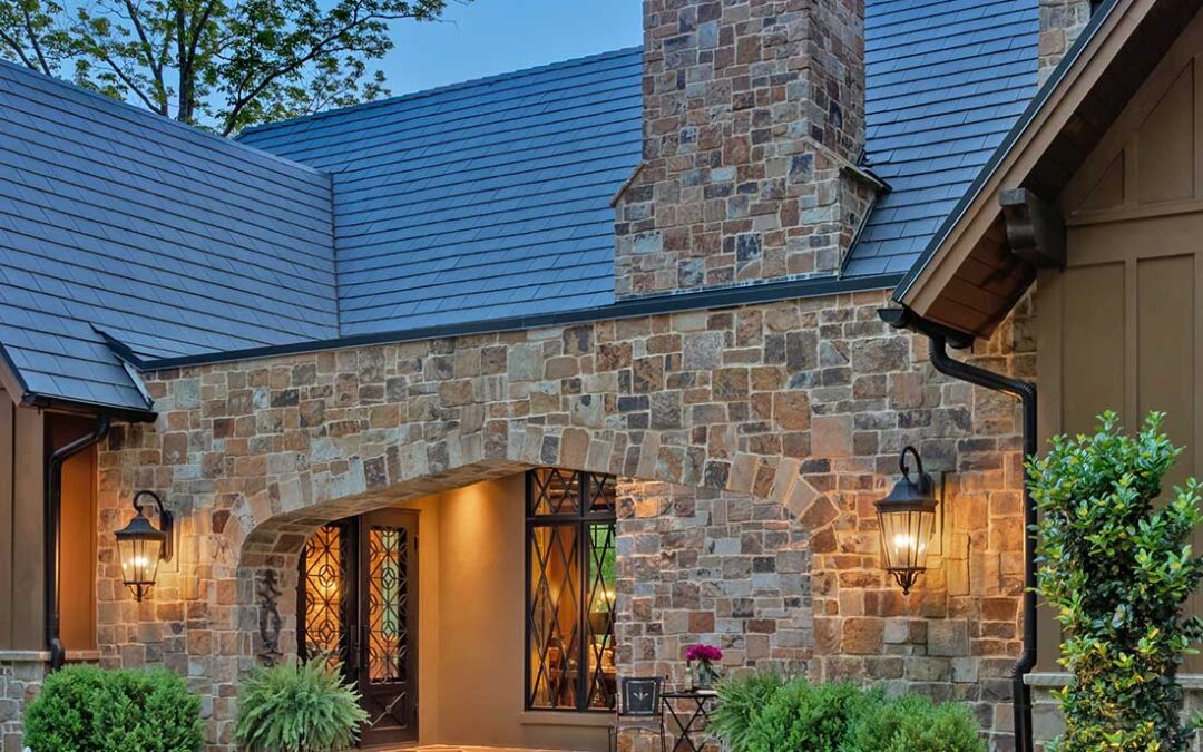 Exterior, stone fascia. Arched entry. Photographed during the evening.