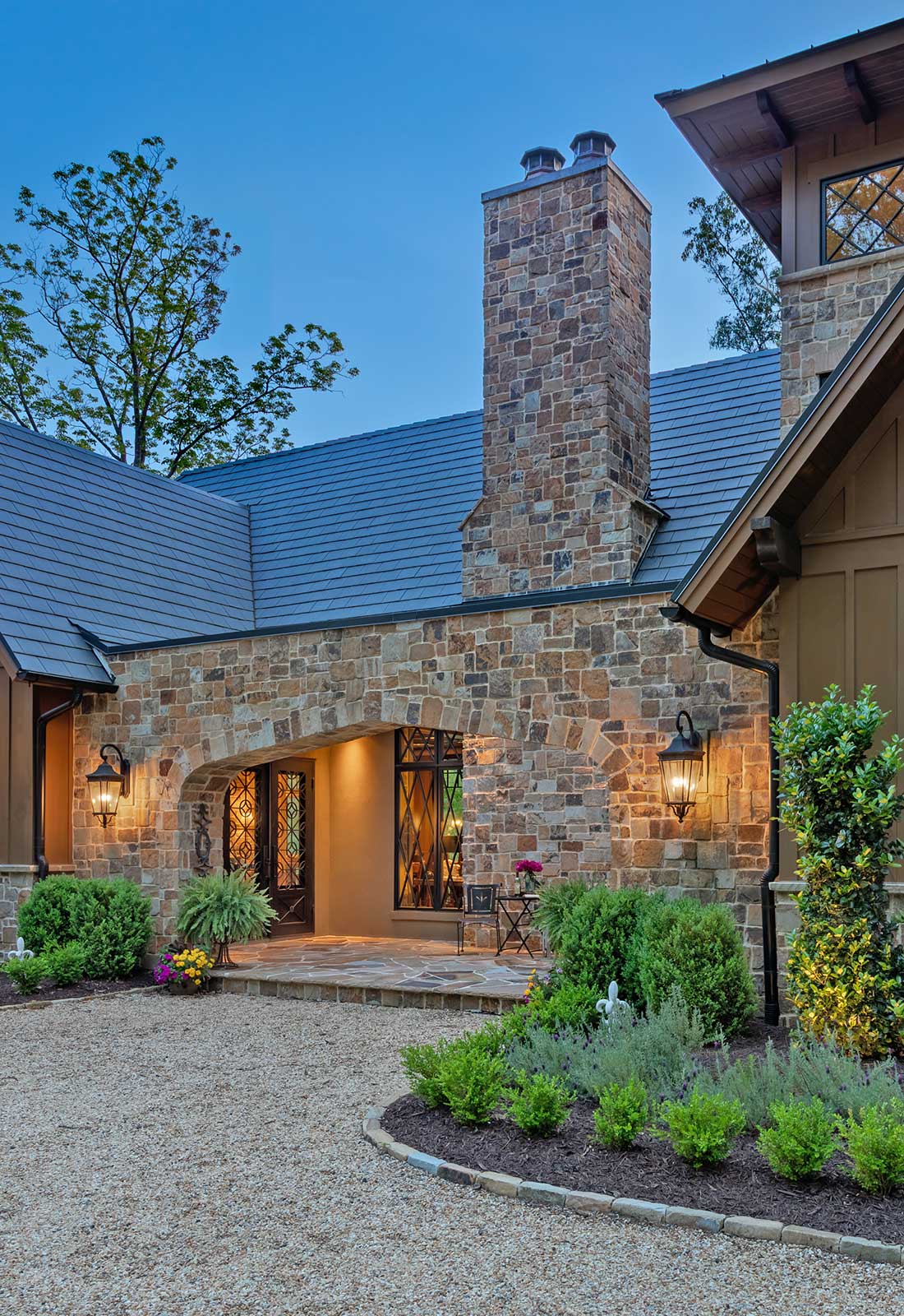 Exterior, stone fascia. Arched entry. Photographed during the evening.