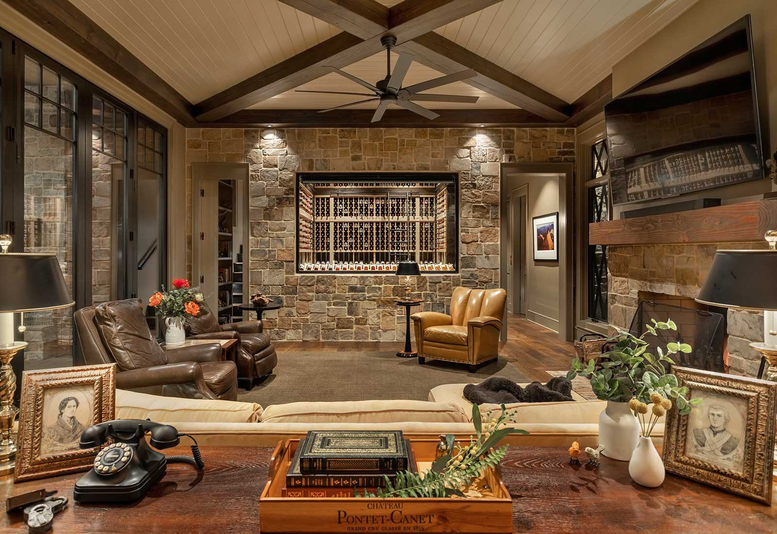 Living room, wine room, cozy furnishings, stone walls.