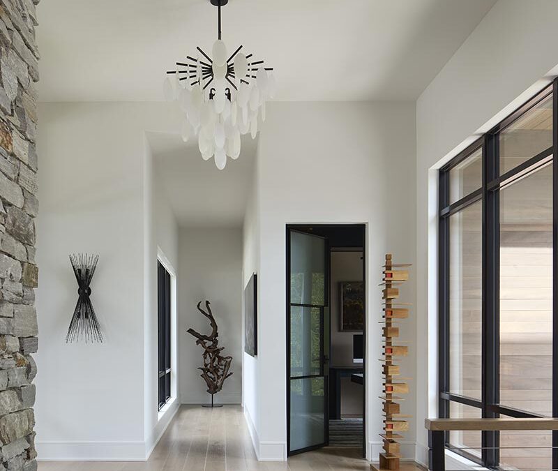 A foyer filled with light enhances the beautiful artwork and light fixtures