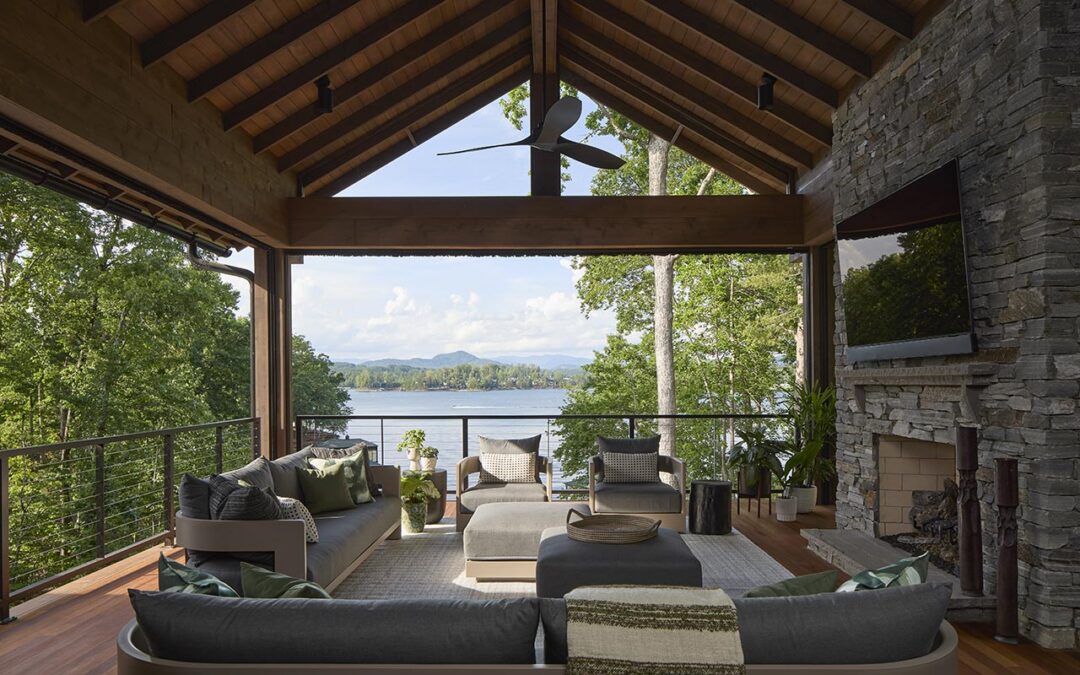 Second-story covered porch with stone fireplace, overlooking Lake Keowee and Blue Ridge Mountains