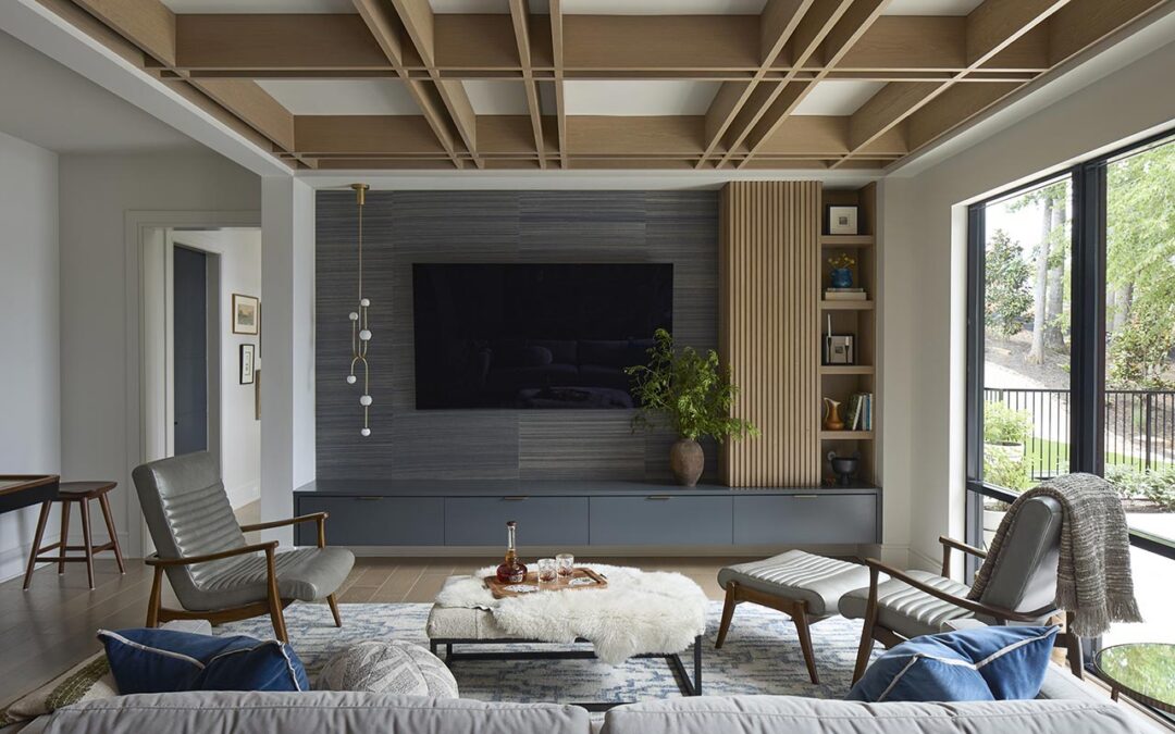 Bonus room on first floor of home with custom cabinetry and coffered ceilings