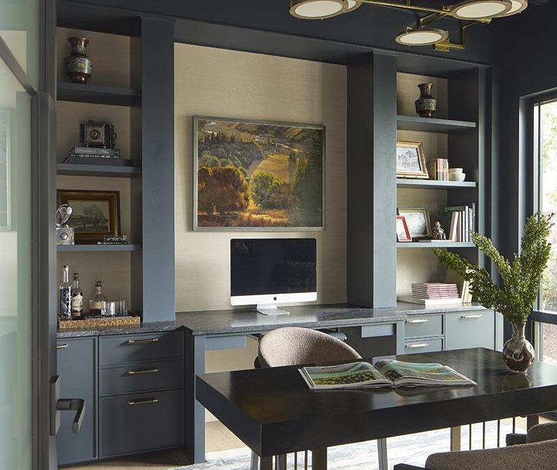 Home study with muted dark colors and custom cabinetry with coffered ceiling
